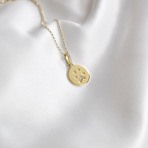 beautiful diamond filled paw print charm made from yellow gold 