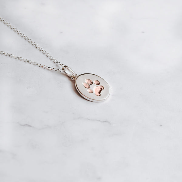 Sterling Silver oval paw print charm necklace with paw print embedded with 24k rose gold 