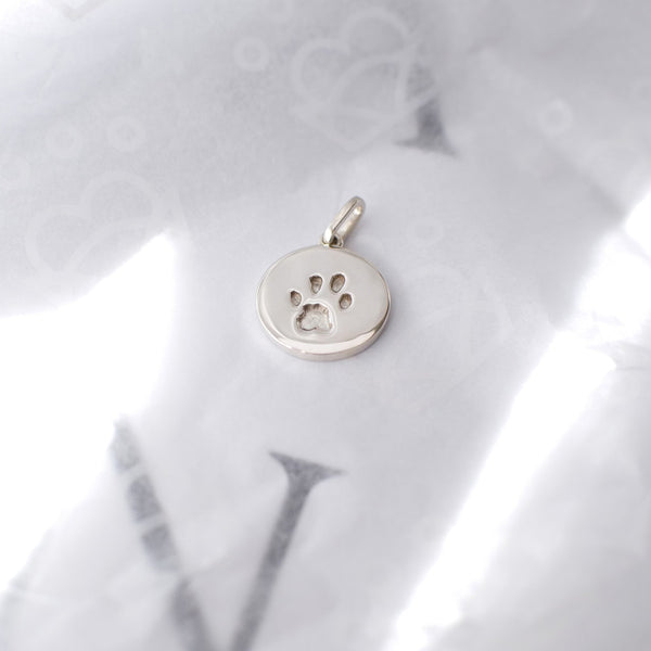 Sterling silver paw print charm jewellery with dog print embedded in silver