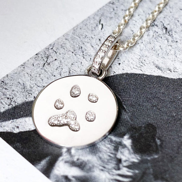 White paw print charms filled with diamonds 