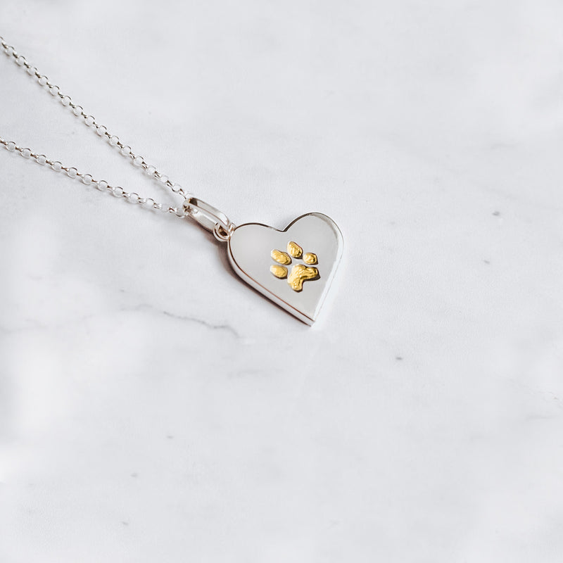 Classic sterling silver paw print charm necklace with embedded paw print filled with 24k yellow gold