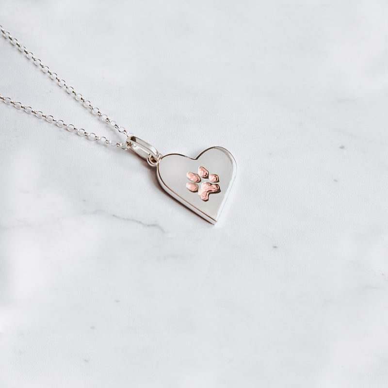 Classic sterling silver paw print charm necklace with embedded paw filled with 24k rose gold 